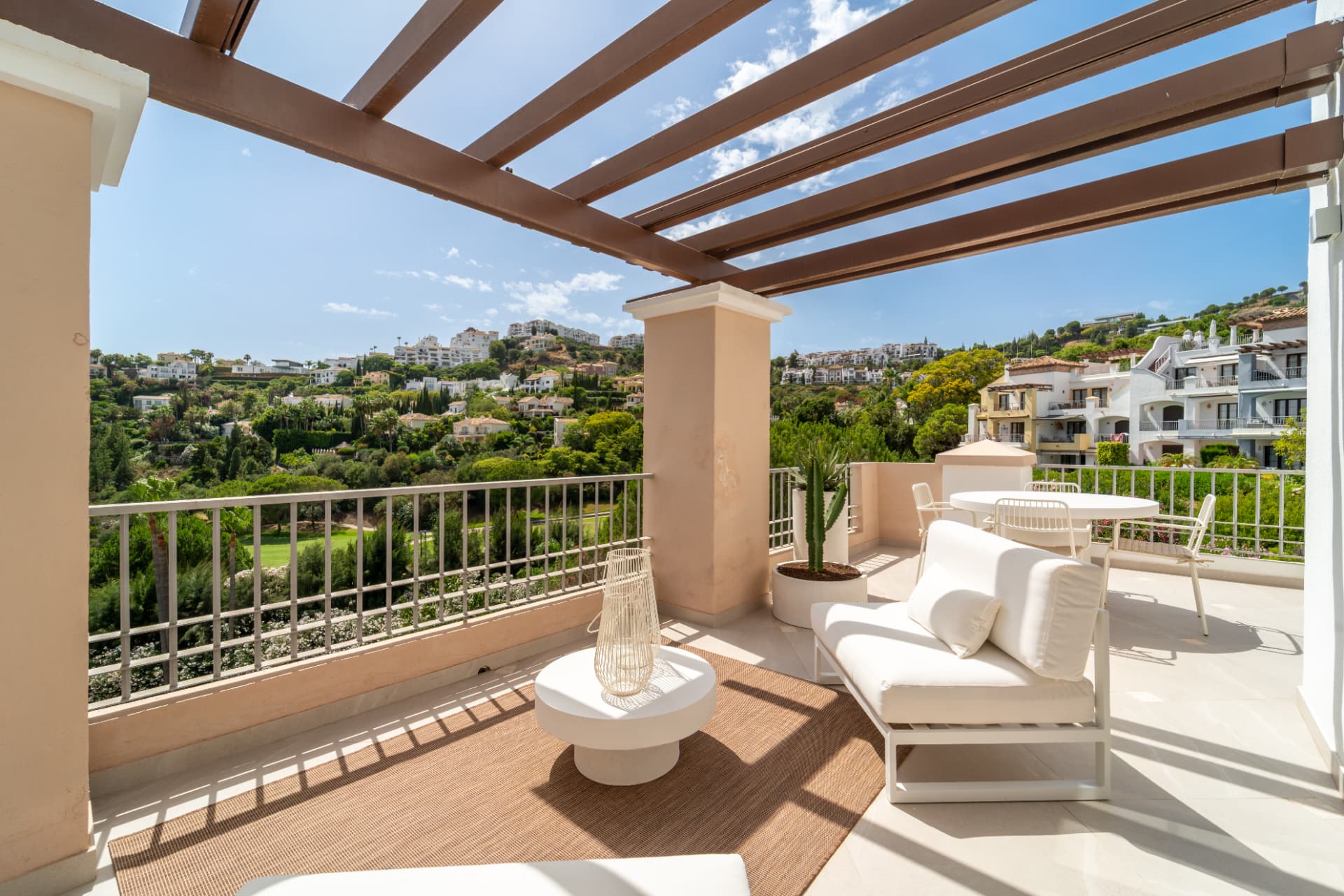 Covered terrace with lounge seating and views over the golf course