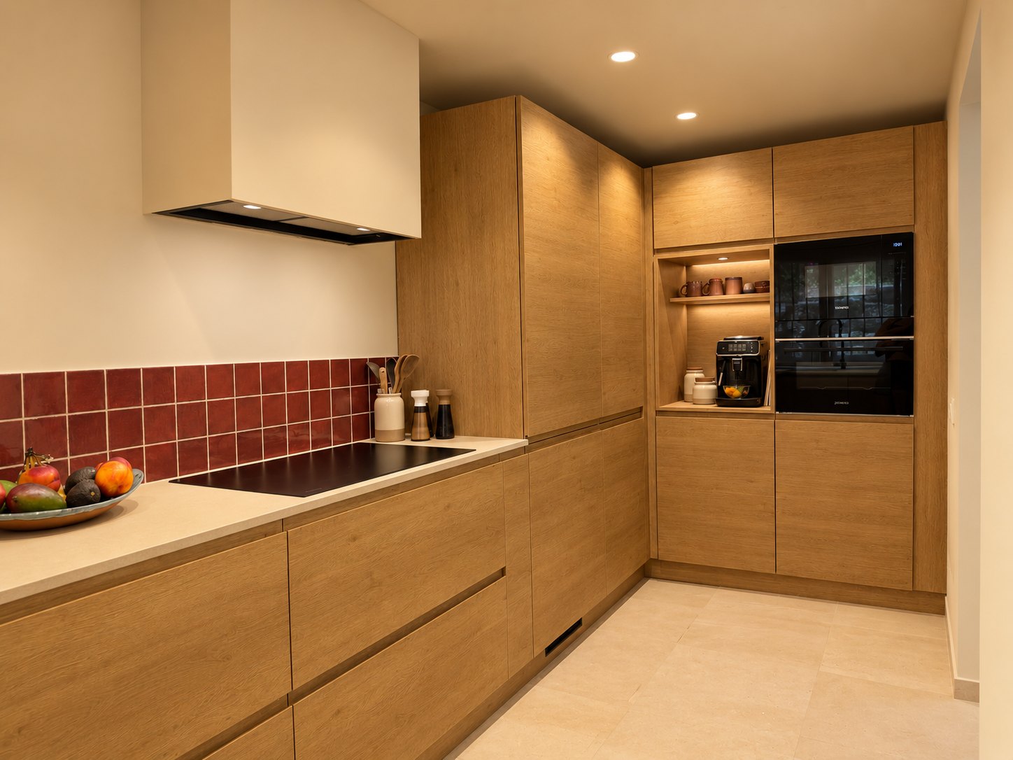 Kitchen in Alhaurín el Grande after: full-height oak units with built-in ovens and a lit coffee nook