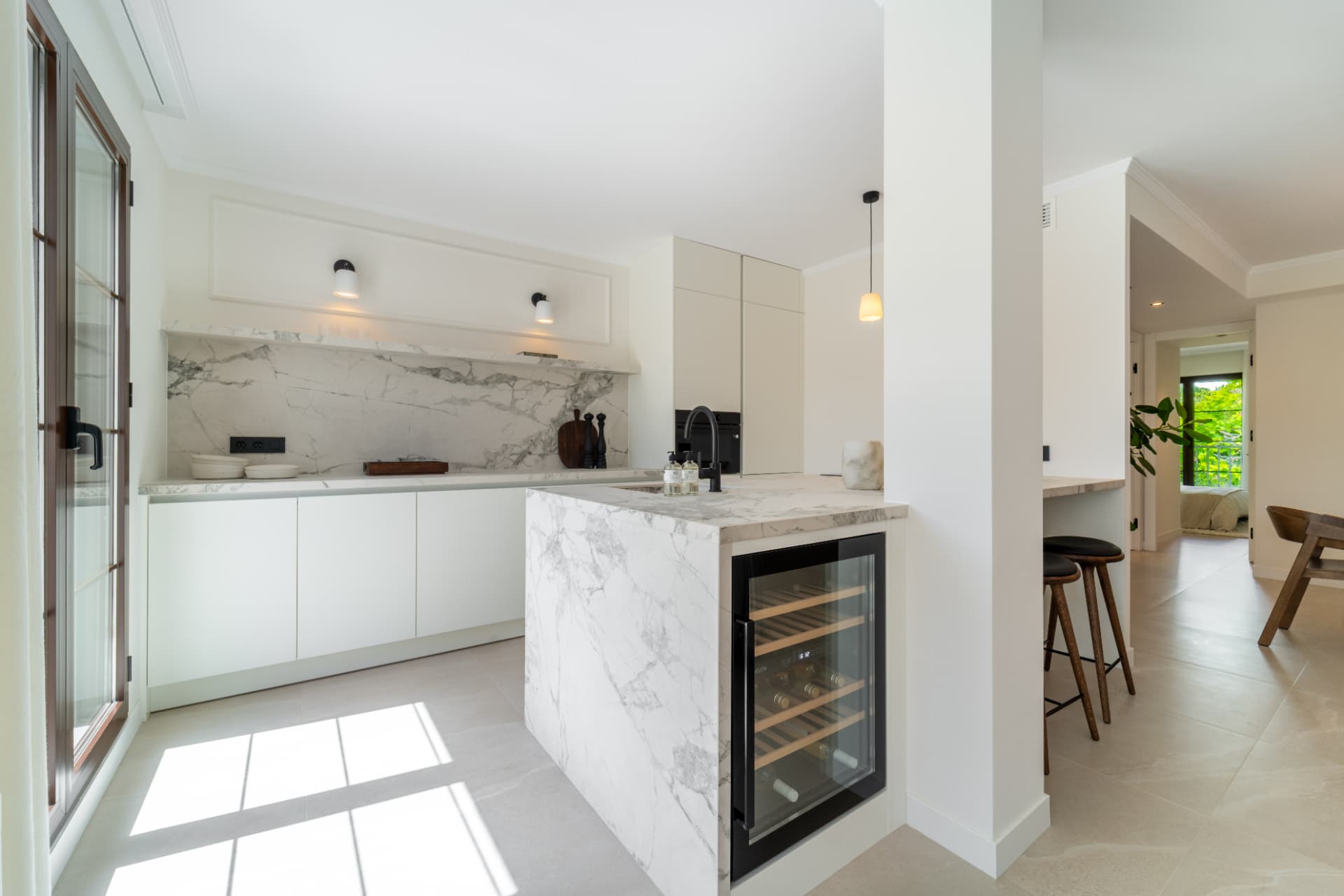 Kitchen with marble island, wine fridge and bar stools