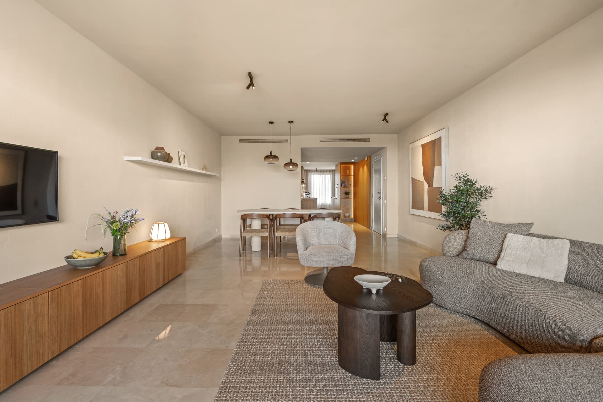 The living room and dining area, with the kitchen beyond down the hall