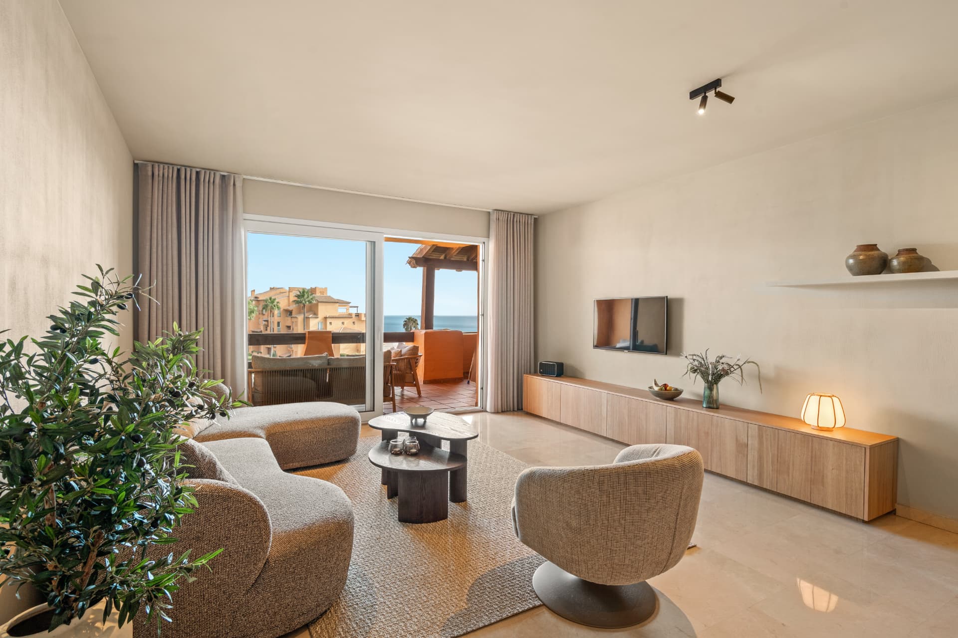 The living room opening onto the terrace, with the sea beyond