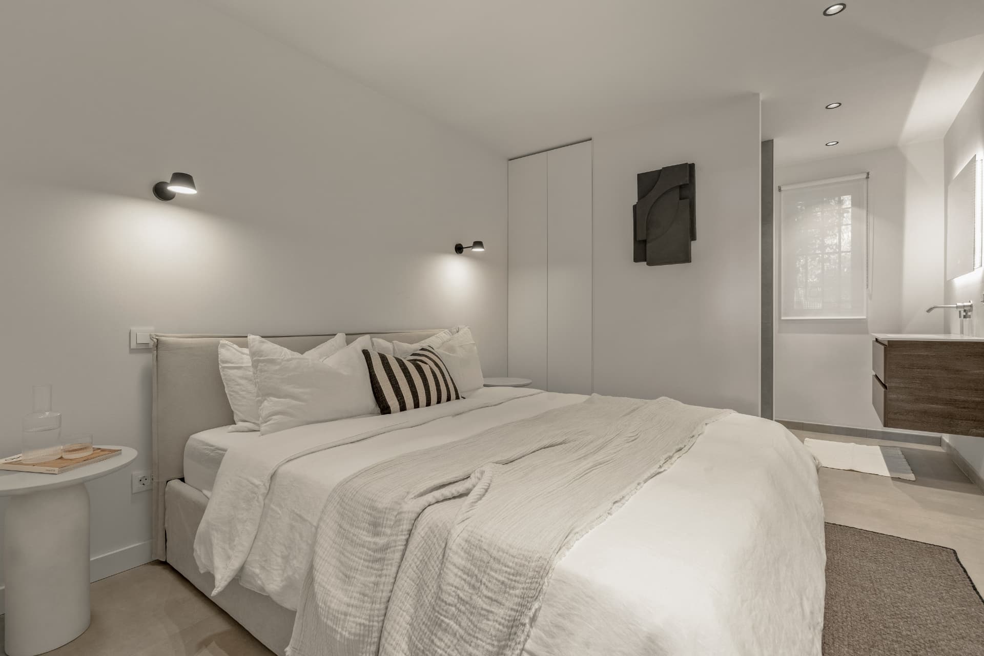 Bedroom with open bathroom behind
