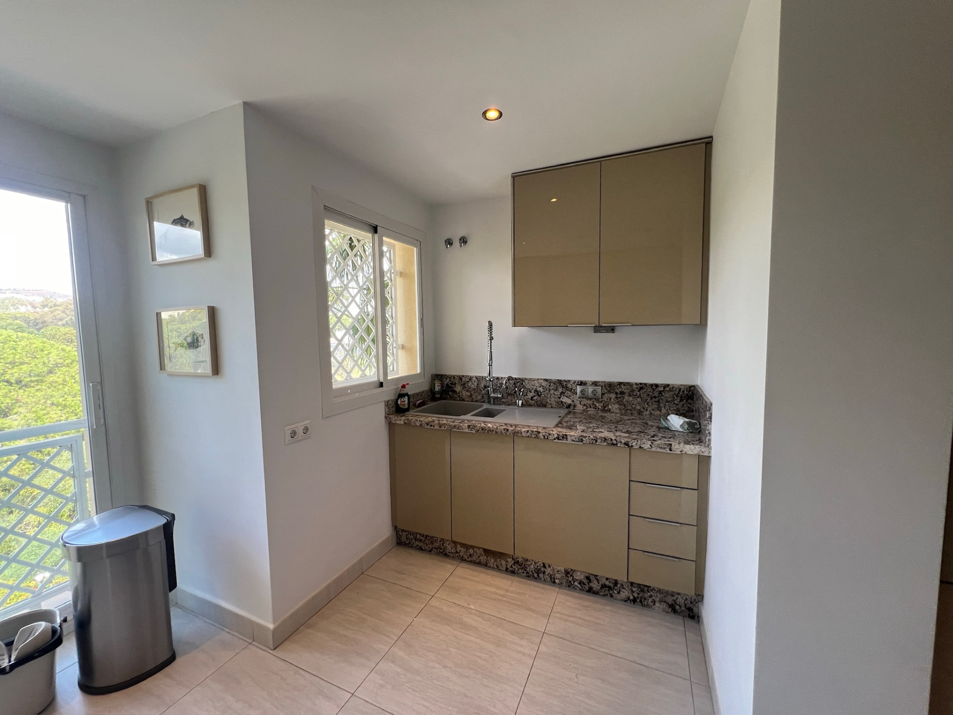 The kitchen before: the sink nook with granite worktop and a spring faucet